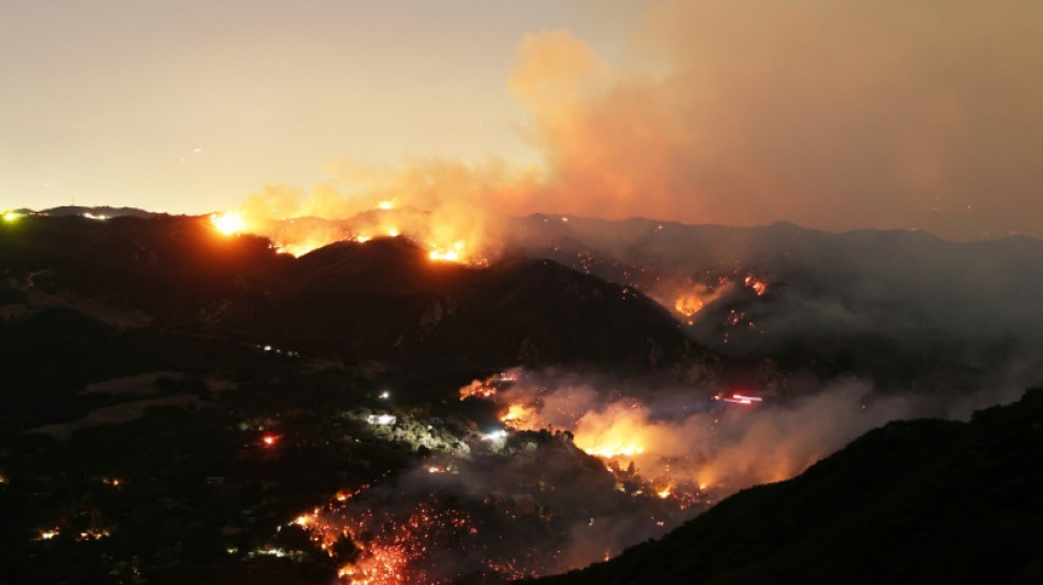 Los Angeles investigates fire blame as curfew enforced